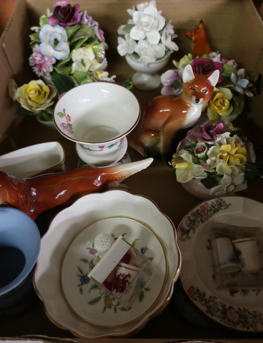 Box containing a selection of various decorative ceramics including a Beswick seated fox, Wedgwood