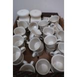 Large selection of Harvest pattern teacups, storage jars, teapots, and kitchenware