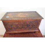 Carved oak rectangular box with hinged top on raised bracket feet (66cm x 31cm x 40cm)