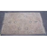 Chinese embossed washed wool rug, beige ground with central floral medallion surrounded by floral