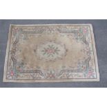 Chinese embossed washed woollen rug, beige ground with central floral medallion and floral pattern