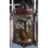 19th C mahogany bevelled edge rectangular wall mirror, with fretwork detail and crested with profile