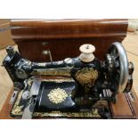 Walnut cased vintage Jones Sewing Machine Family C.S315594 with plaque for Carltons' Ltd Drapers &