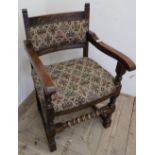 Oak framed armchair with upholstered seat and back on turned supports
