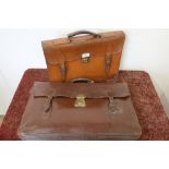 Vintage tan leather satchel and another similar larger satchel/briefcase bag with brass lock (2)