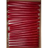 Approximately 200 boxed as new dark red tapered dining candles