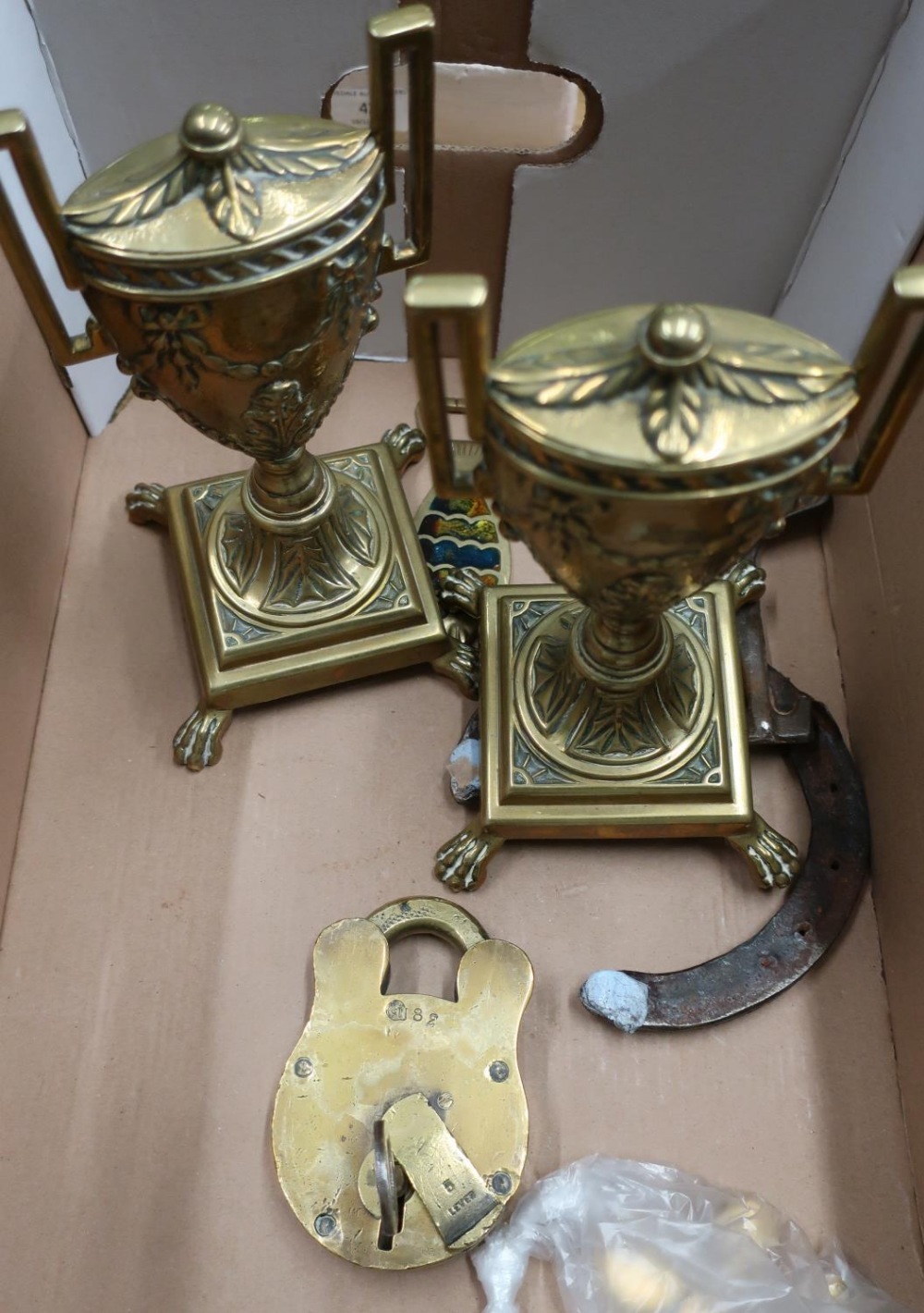 Pair of 19th C brass urn shaped garnitures on stepped square weighted bases and lion paw feet, a