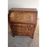 Modern mahogany bureau with fall front revealing fitted interior above four long drawers, on bracket