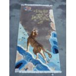 Chinese embossed washed woollen rug depicting a stalking tiger (90cm x 186cm)