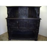 18th C and later elaborately carved dark oak court cupboard, with raised pediment above central