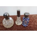 A cut glass dressing table bottle with hallmarked silver top, another cut glass dressing table