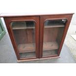 Late Victorian mahogany bookcase enclosed by two glazed cupboard doors with later stained pine