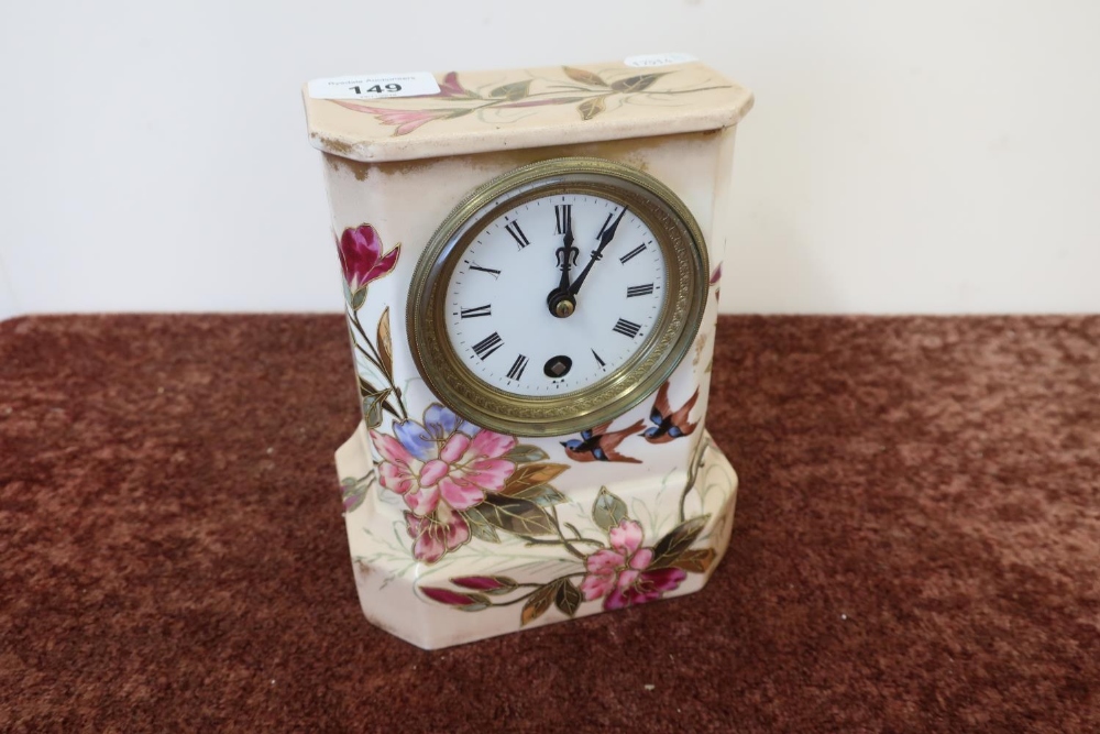 Ceramic cased mantel clock with white enamel dial, the case decorated with birds and foliage, the