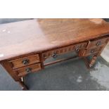 Old Charm style oak dressing table with single central drawer flanked by four short drawers (width