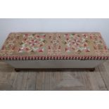 Victorian ottoman with wool-work upholstered hinged top, the body of tapering rectangular form on