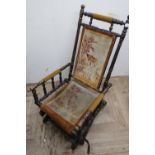 Victorian American style rocking chair with upholstered seat, back and arms on turned supports
