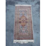 Traditional Middle Eastern pattern wool rug with central floral medallion and geometric pattern