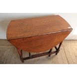Oak drop leaf table on turned supports