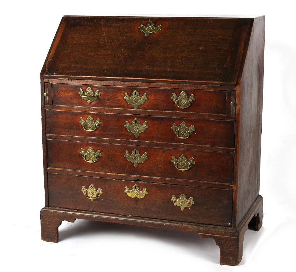 Property of a gentleman - a George III oak fall-front bureau, with four long graduated drawers, on