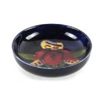 Property of a lady - a Moorcroft orchid pattern shallow bowl, with original paper label to