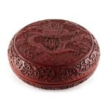 A Chinese carved cinnabar lacquer circular box & cover, decorated with a five clawed dragon
