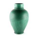 A large C.H. Brannam Barnstaple green glazed pottery baluster vase, 17.7ins. (45cms.) (see