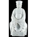 A Chinese Dehua blanc de Chine porcelain figure of a seated dignitary, Kangxi period (1662-1722),