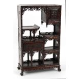 A late 19th century Chinese carved hongmu display cabinet of small size, fitted with a door, a