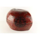 A large Chinese lacquer peach shaped box, decorated with shou characters, bats & precious objects,