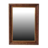 Property of a gentleman - a carved oak rectangular framed wall mirror, 34.85 by 25.3ins. (88.5 by