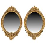 Property of a lady - a pair of Victorian gilt composition oval framed wall mirrors, each 29.