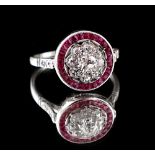 An unmarked white gold ruby & diamond ring, the flowerhead centre with an Old European cut diamond