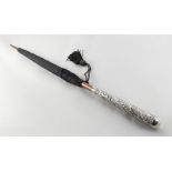 Property of a lady - an early 20th century unmarked white metal handled umbrella (see illustration).