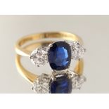 An 18ct yellow gold certificated sapphire & diamond three stone ring, the oval cushion cut