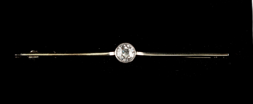 Property of a gentleman - a diamond solitaire bar brooch, the millegrain set round brilliant cut