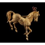 An 18ct yellow gold brooch modelled as a saddled pony, with leaf crestings set with three round