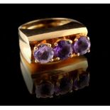 Property of a lady - a modern 14ct yellow gold amethyst three stone ring, approximately 9.6 grams,