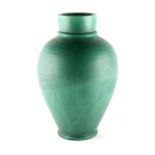 A large C.H. Brannam Barnstaple green glazed pottery baluster vase, 17.7ins. (45cms.) (see