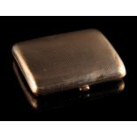 Property of a lady - a 9ct gold cigarette case, with engine turned decoration, 3.15ins. (8cms.) long