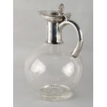 Property of a deceased estate - a Victorian silver topped clear glass carafe, with hinged lid,