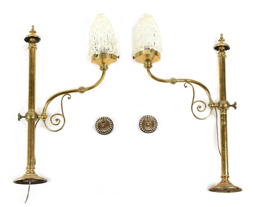 Property of a gentleman - a pair of early 20th century brass wall lights with clear glass shades,