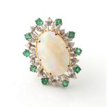 Property of a gentleman - an opal diamond & emerald ring, the large oval opal measuring