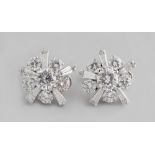 A fine pair of 18ct white gold diamond flowerhead earrings by Kutchinsky, each with a certificated
