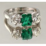 A platinum emerald & diamond three stone ring, the certificated Colombian emerald of vibrant