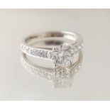 A good certificated diamond solitaire ring, the round brilliant cut diamond weighing 1.26 carats,