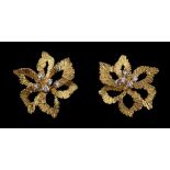 A pair of unmarked yellow gold (tests 18ct) & diamond floral earrings, of pierced leaf design with