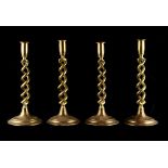 Property of a gentleman - a set of four early 20th century brass hollow barleytwist candlesticks,