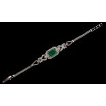 Property of a gentleman - an emerald & diamond bracelet, the octagonal cut emerald measuring