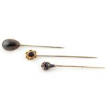Property of a lady - a blue enamel & seed pearl stickpin, possibly Russian; together with two garnet