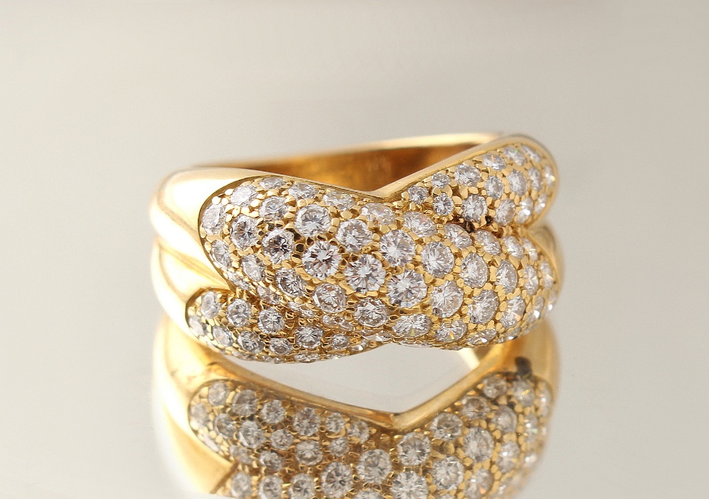 A Cartier 18ct yellow gold diamond crossover ring, circa 1992, signed Cartier & numbered with